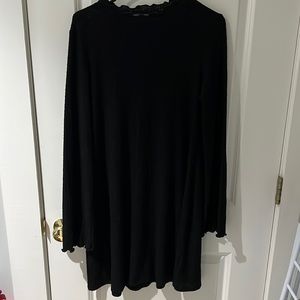 Light weight black sweater dress with rippled neckline and sleeve detail.